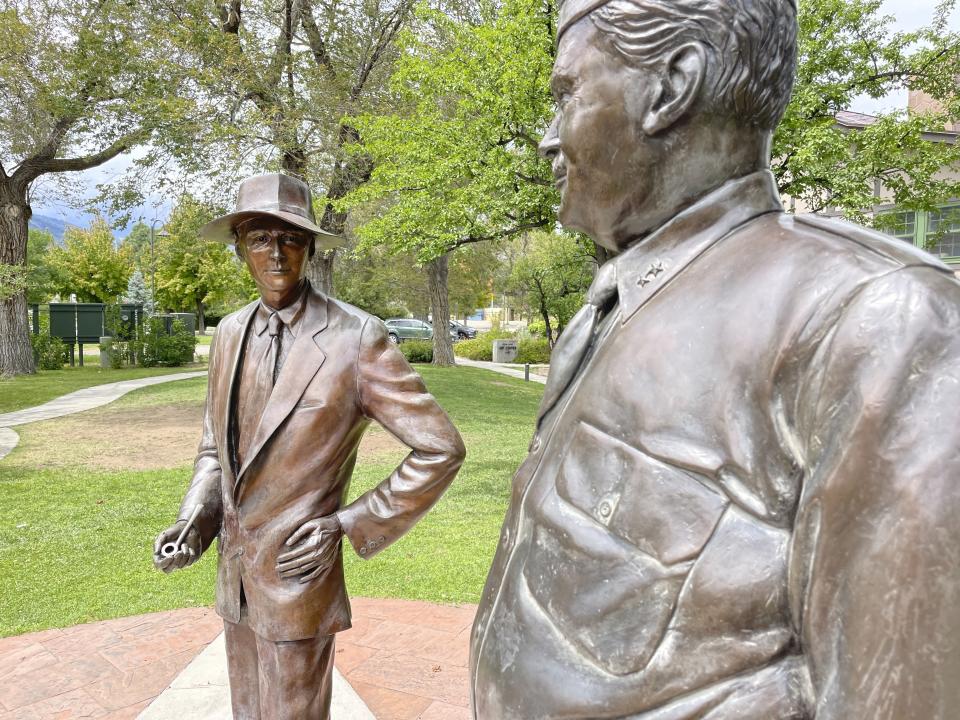 Bronze statues of physicist J. Robert Oppenheimer, left, and Gen. Leslie Groves stand outside a historic building in Los Alamos, N.M., Aug. 13, 2023. Los Alamos was the perfect spot for the U.S. government's top-secret Manhattan Project. Almost overnight, the remote location was transformed to accommodate thousands of scientists, soldiers and other workers who were racing to develop the world's first atomic bomb. The community is facing growing pains again, 80 years later, as it works to modernize the country's nuclear arsenal. (AP Photo/Susan Montoya Bryan)