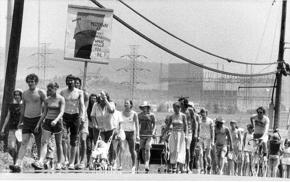 FILE - In this Aug. 6, 1979 file photo, protestors march past the Vermont Yankee nuclear power plant in Vernon, Vt. Vermont Yankee's initial 40-year license expires Wednesday, March 21, 2012. It has won approval from the federal Nuclear Regulatory Commission to operate an additional 20 years. The state Public Service Board has yet to rule on the plant's future, but it's expected the Vernon reactor will continue operating in the meantime. (AP Photo/Donna Light, File)