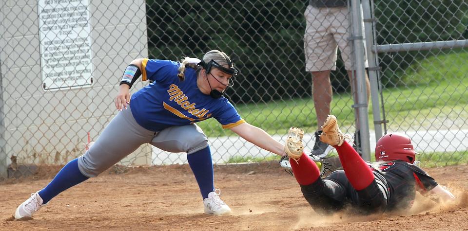 Mitchell's Aktyn Brown (35) attempts to make a tag on an Orleans player at third. The player was safe, and Orleans defeated PLAC rival Mitchell, 7-5, Tuesday, April 30, 2024. Mitchell's next game was Friday when it hosted South Central.