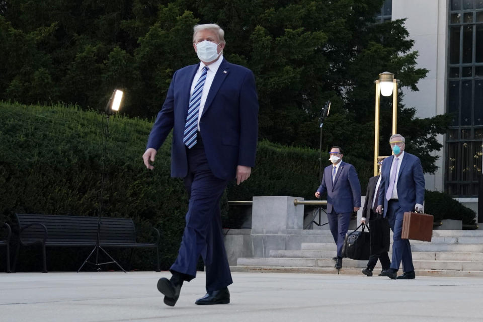 President Donald Trump walks out of Walter Reed National Military Medical Center to return to the White House after receiving treatments for covid-19, Monday, Oct. 5, 2020, in Bethesda, Md. (AP Photo/Evan Vucci)