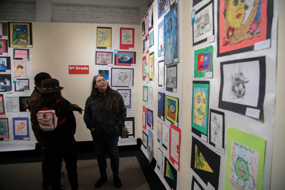 Museum goers look at some of more than 1,000 pieces of artwork during the opening reception for the 93rd annual Robert T. McKee Student Art Show at the Haggin Museum in Stockton on Feb. 3, 2024. More than 1,000 pieces of art from students from all around the county are displayed in the show which runs at the museum until March 17.