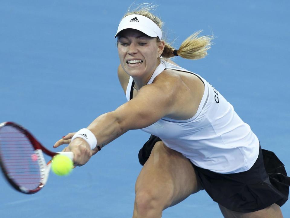 Angelique Kerber of Germany plays a shot in her match against Casey Dellacqua of Australia during the Fed Cup semi-finals between Australia and Germany in Brisbane, Australia, Saturday, April 19, 2014. (AP Photo/Tertius Pickard)