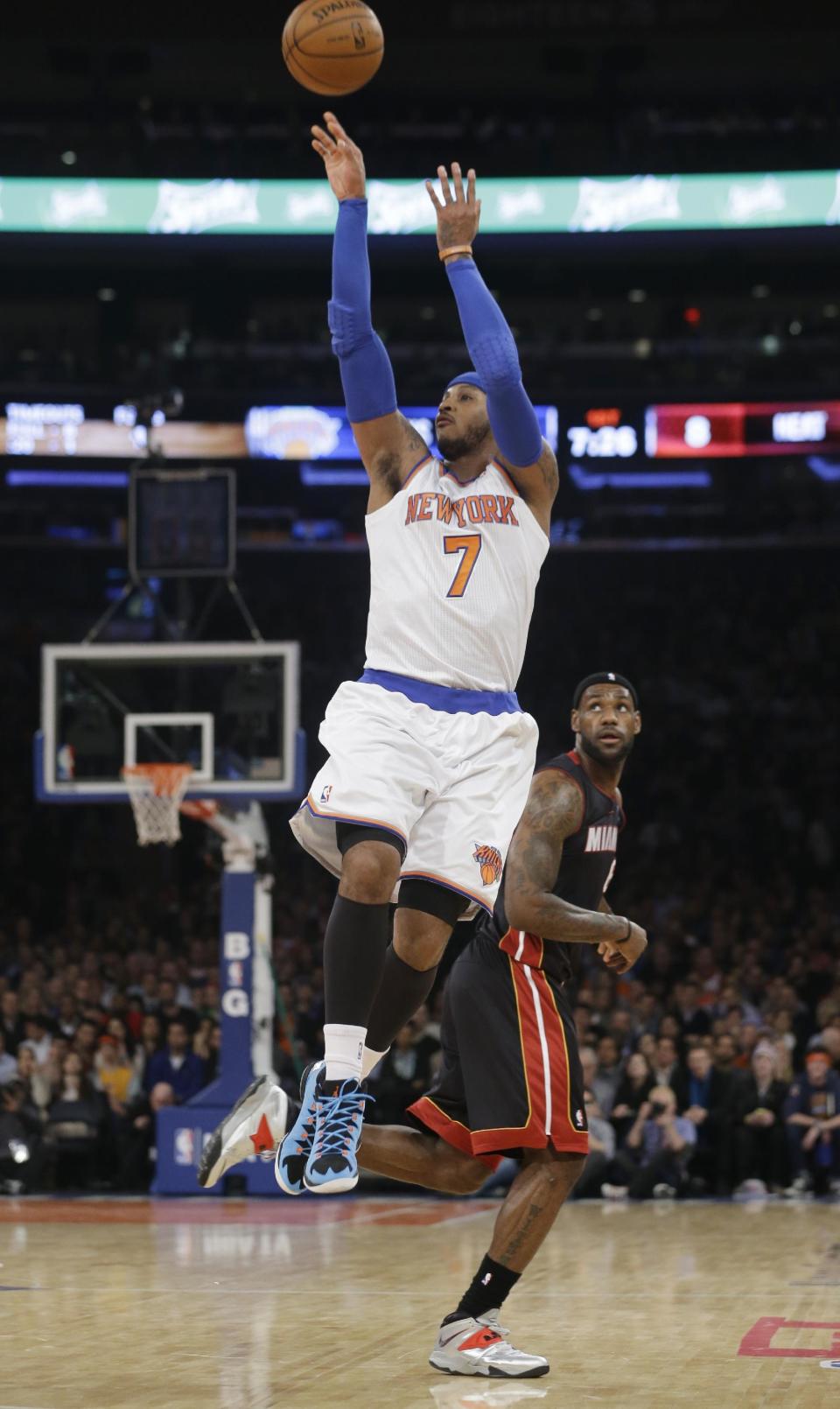 New York Knicks' Carmelo Anthony (7) gets past Miami Heat's LeBron James to shoot during the first half of an NBA basketball game on Thursday, Jan. 9, 2014, in New York. (AP Photo/Frank Franklin II)