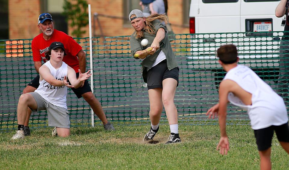 Chesnie Patton connects with a pitch from Max Ohl as Tanner James plays catcher during the Wifflefest high school tournament Friday, July 1, 2022 at Southview Grace Brethren Church. TOM E. PUSKAR/ASHLAND TIMES-GAZETTE