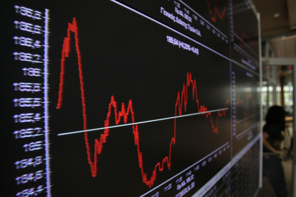 A man passes an array of displays at the Stock Exchange in Athens on Friday, May 25, 2012. Uncertainty over Greece's future in the eurozone has hammered markets ahead of June 17 general elections in the crisis-hit country. The Greek share index touched new 22-year lows, dipping below 500 points. (AP Photo/Thanassis Stavrakis)