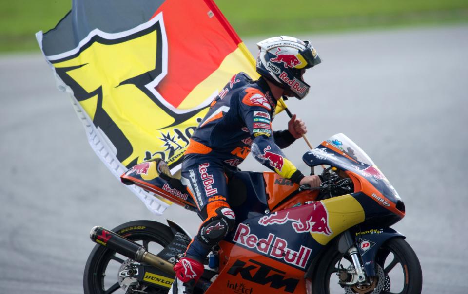 KUALA LUMPUR, MALAYSIA - OCTOBER 21: Sandro Cortese of Germany and Red Bull KTM Ajo celebrates with the flag after winning the Moto3 race, sealing victory in the Moto3 Championship, during the MotoGP Of Malaysia at Sepang Circuit on October 21, 2012 in Kuala Lumpur, Malaysia. (Photo by Mirco Lazzari gp/Getty Images)