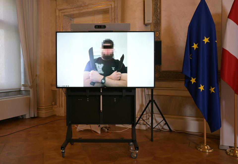 A screen displays a photo of a young man posing with two knives. His face is blurred.