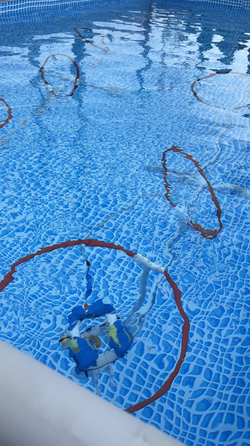An underwater robot surfaces at the end of the Obstacle Hoops Course before it resubmerges and travels back to the starting point during the Michigan Regional SeaPerch Underwater Robotics Competition March 18 at the University of Michigan in Ann Arbor.