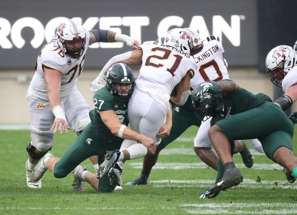 Michigan State Spartans linebacker Cal Haladay (27) tackles Minnesota Golden Gophers running back Bryce Williams (21) during the second half at Spartan Stadium, Saturday, Sept. 24, 2022.