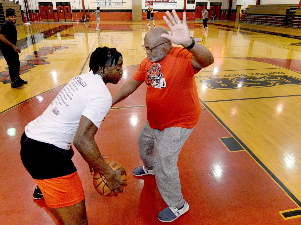 Ali Upshaw, right, works with Valor Komolafe during basketball practice at Dewey Gym at Springfield High School Wednesday, January 3, 2024.