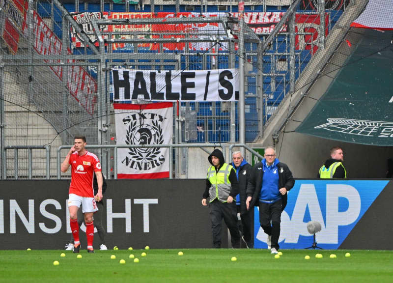 Union Berlin fans repeatedly throw tennis balls onto the pitch in protest against the German Football League's (DFL) plans to bring in investors during the German Bundesliga soccer match between TSG 1899 Hoffenheim and 1. FC Union Berlin at the PreZero Arena. Jan-Philipp Strobel/dpa