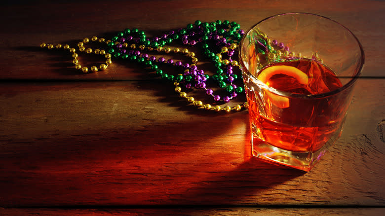 Sazerac cocktail with Mardi Gras beads