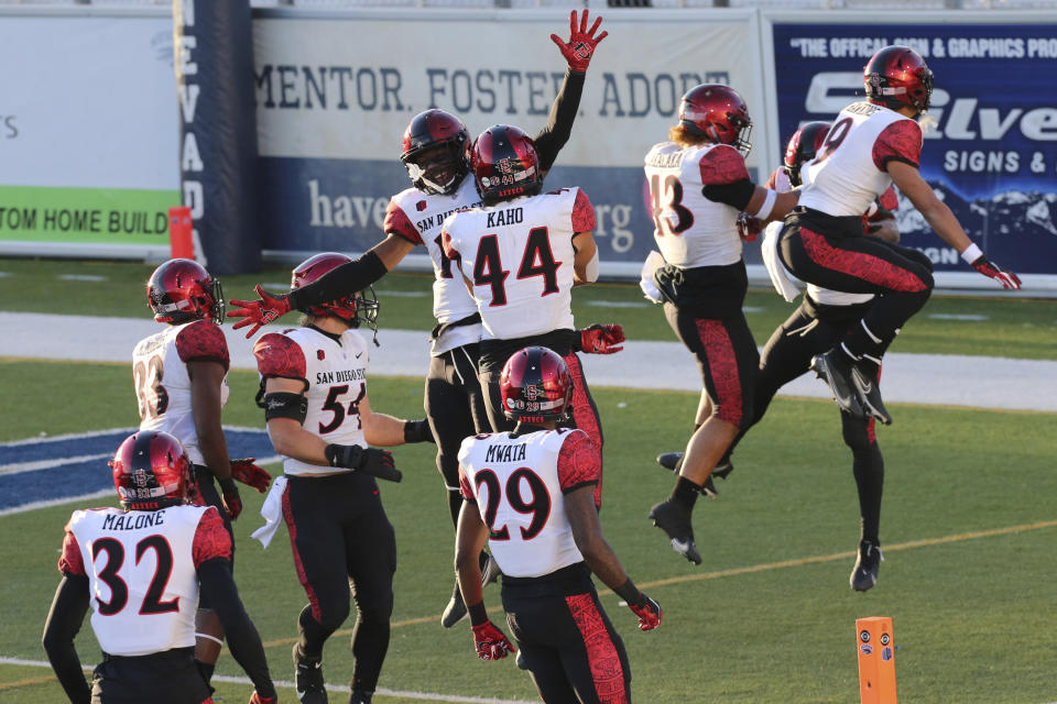 San Diego State players celebrate an interception late into the second half of an NCAA college football game against Nevada, Saturday, Nov. 21, 2020, in Reno, Nev. (AP Photo/Lance Iversen)