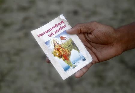 A volunteer of the Hindu nationalist organisation Rashtriya Swayamsevak Sangh (RSS) holds a prayer book during a training session at Tatiberia village in West Bengal, India, in this May 20, 2015 file photo. REUTERS/Rupak De Chowdhuri