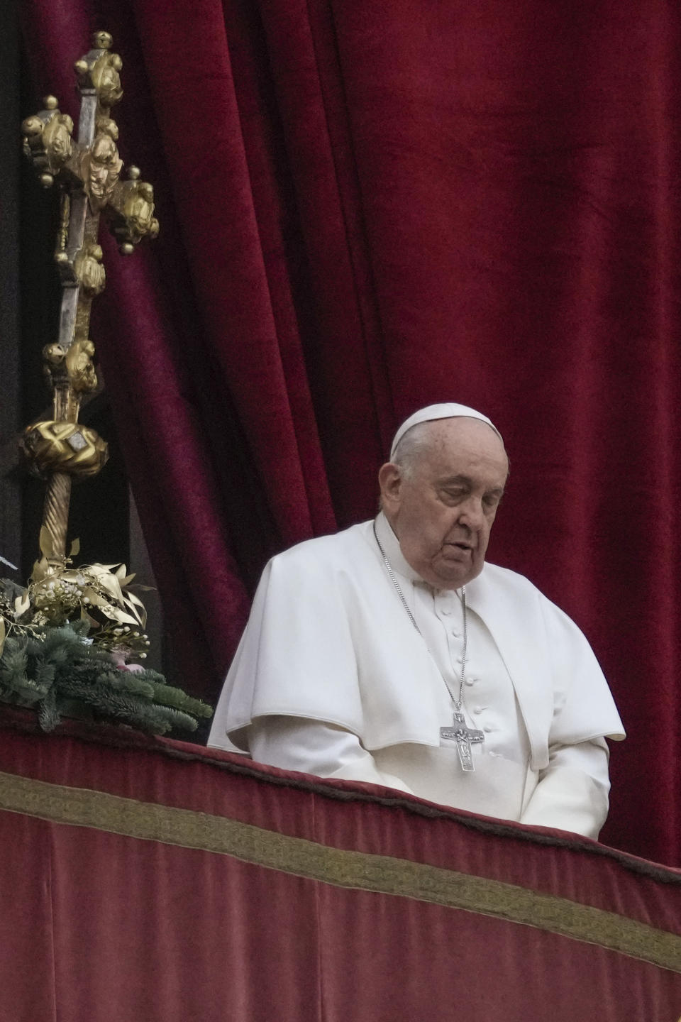 Pope Francis stands before delivering the Urbi et Orbi (Latin for 'to the city and to the world' ) Christmas' day blessing from the main balcony of St. Peter's Basilica at the Vatican, Monday Dec. 25, 2023. (AP Photo/Gregorio Borgia)