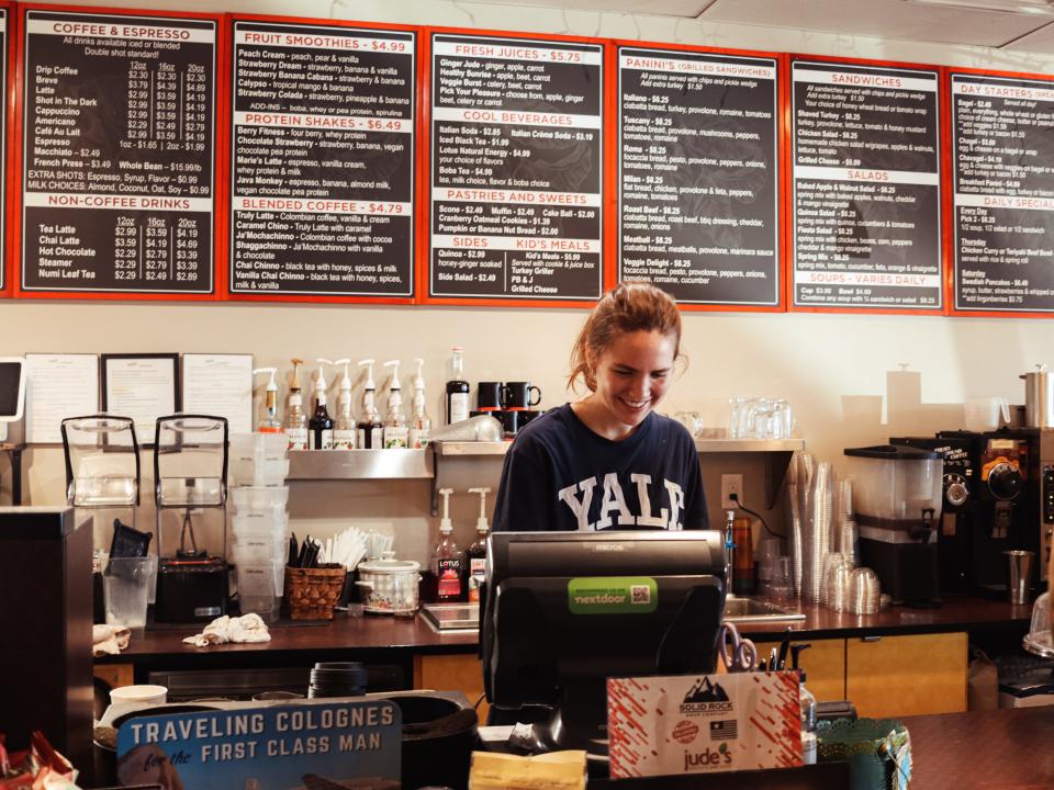 Jude’s manager Bobby Yales helps a customer during the morning coffee rush.