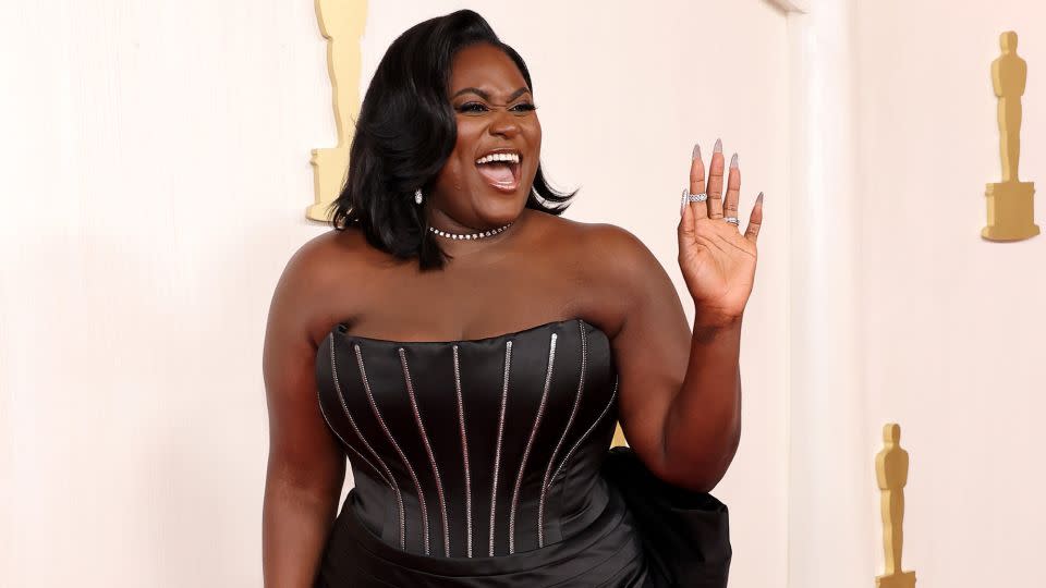 Danielle Brooks arrived in a bedazzled satin dress with exposed metal boning detailing, by Dolce & Gabbana. - Mike Coppola/Getty Images