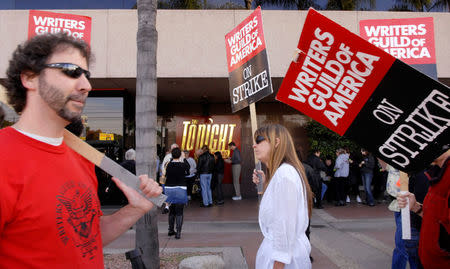 FILE PHOTO: Audience members line up as striking Writers Guild of America members picket in front of NBC studios in Burbank, California, U.S. on January 2, 2008. REUTERS/Phil McCarten/File Photo