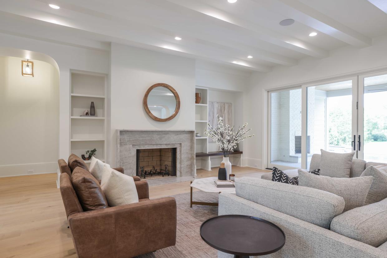Part of an open plan kitchen, dining, and living area, the great room is anchored by the fireplace but also opens to the back patio space for indoor-outdoor living at 649 Brook Hollow Road.