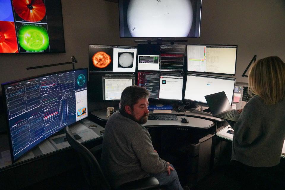 Forecasters monitor satellite feeds and other data at the federal Space Weather Prediction Center in Boulder.