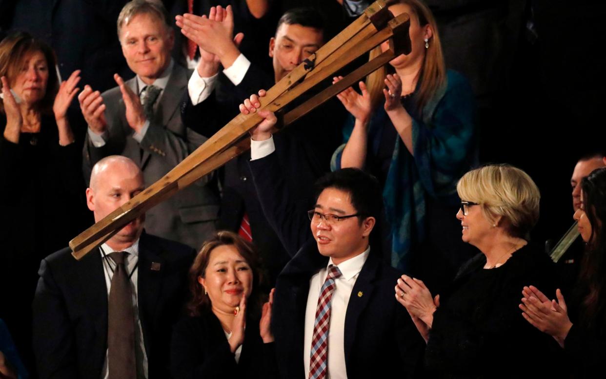 North Korean defector Ji Seong-ho is acknowledged by U.S. President Trump as he delivers his State of the Union  - REUTERS