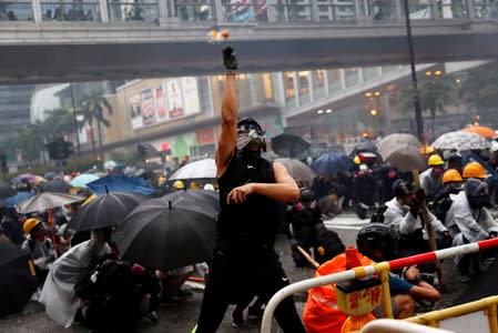 An anti-extradition bill protester throws eggs as protesters clash with riot police during a rally to demand democracy and political reforms, at Tsuen Wan, in Hong Kong