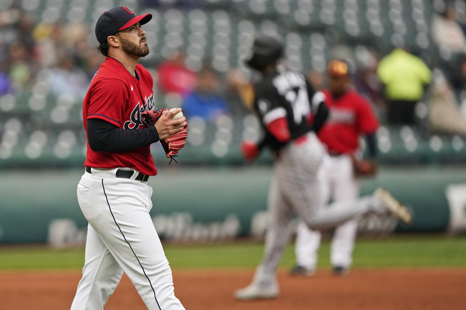 Cleveland Indians starting pitcher Aaron Civale, left, waits for Chicago White Sox's Eloy Jimenez to run the bases after Jimenez hit a solo home run in the second inning in the first baseball game of a doubleheader, Thursday, Sept. 23, 2021, in Cleveland. (AP Photo/Tony Dejak)