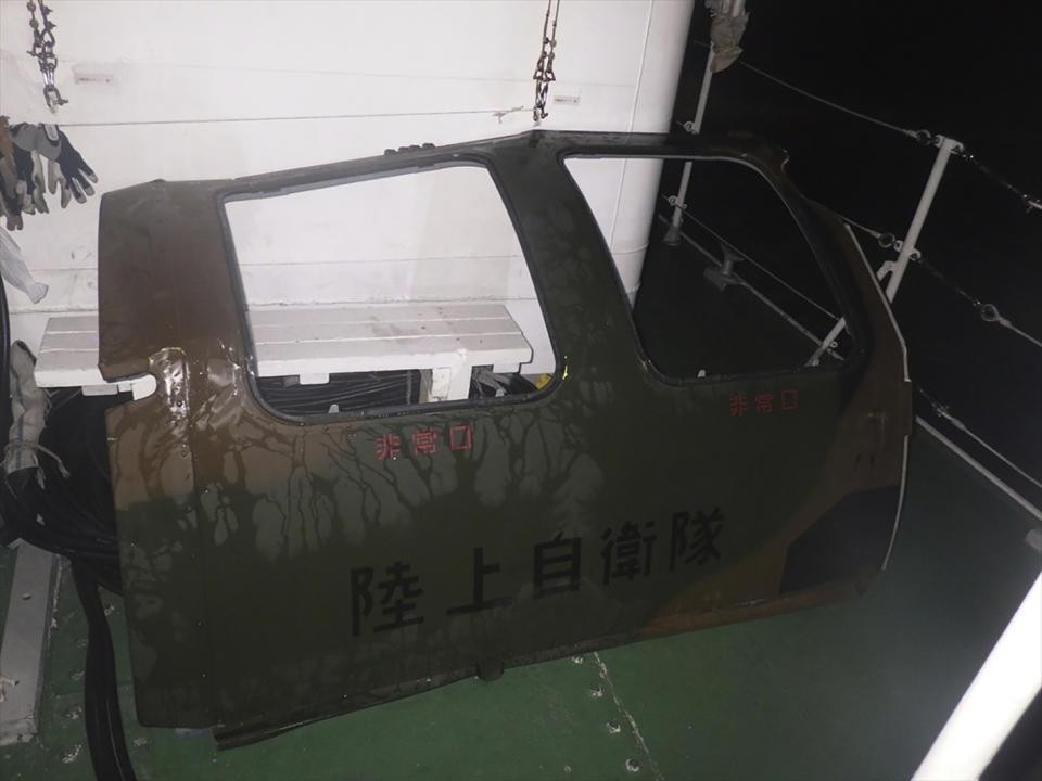 This photo provided by the 11th Regional Japan Coast Guard Headquarters shows the door that the coast guard found and retrieved from the sea, off Miyako Island, Okinawa Prefecture, southern Japan, Friday, April 7, 2023. The words on the door reads Ground Self Defense Force. Search and rescue operation continued Friday and officials said they found a door and other fragments believed to be of a Japanese army helicopter presumed to have crashed into the sea near southern islands with 10 crew members on board. (11th Regional Japan Coast Guard Headquarters via AP)