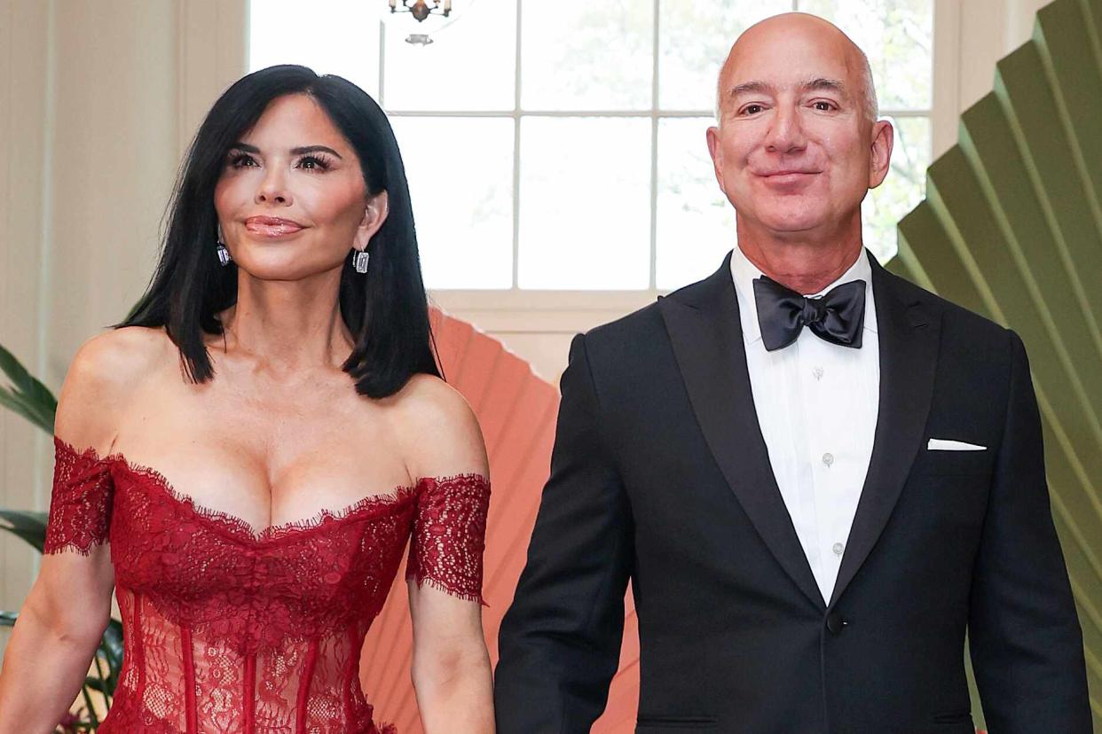 <p>Tasos Katopodis/Getty</p> Amazon founder Jeff Bezos (R) and his fiancee Lauren Sanchez arrive at the White House for a state dinner on April 10