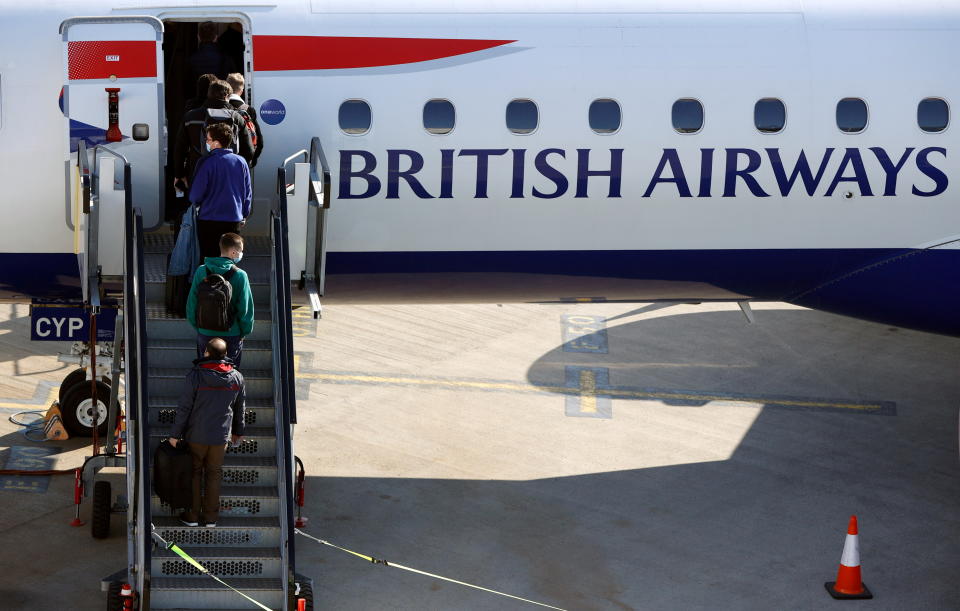 Passengers board a British Airways Embraer 190 aircraft at London City Airport