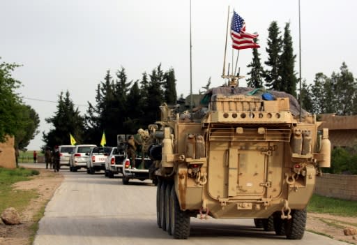 US forces, accompanied by Kurdish People's Protection Units (YPG) fighters, drive their armored vehicles near the northern Syrian village of Darbasiyah, on the border with Turkey in April 2017