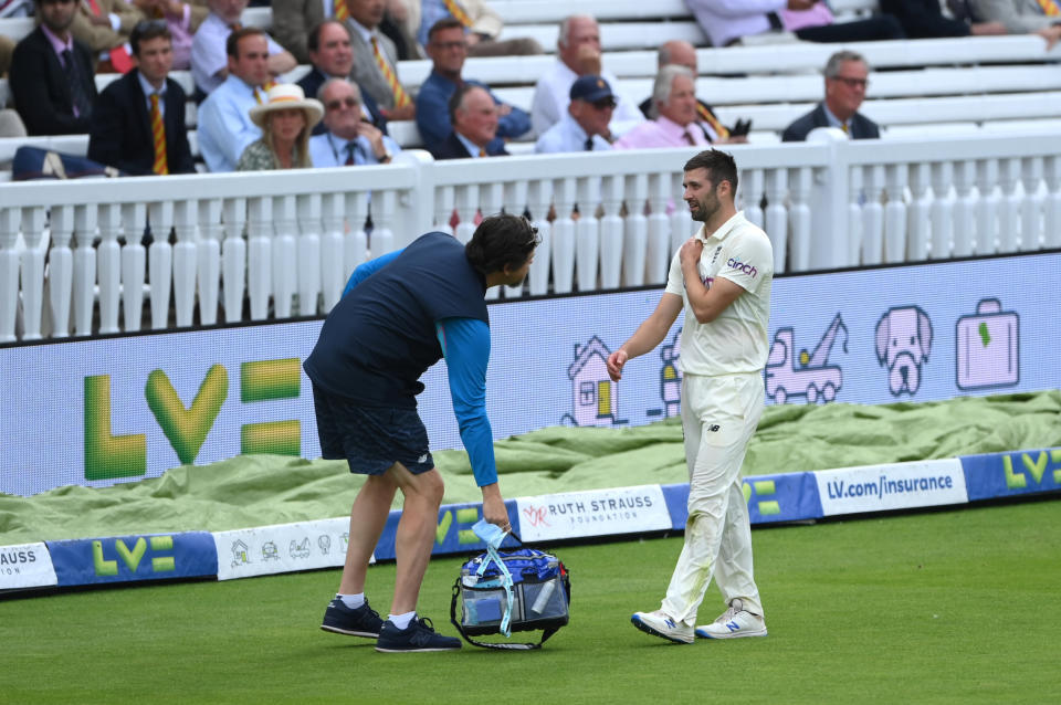 LONDON, ENGLAND - AUGUST 15: England bowler Mark Wood injures his shoulder after attempting to save a boundary during day four of the Second Test Match between England and India at Lord's Cricket Ground on August 15, 2021 in London, England. (Photo by Stu Forster/Getty Images)