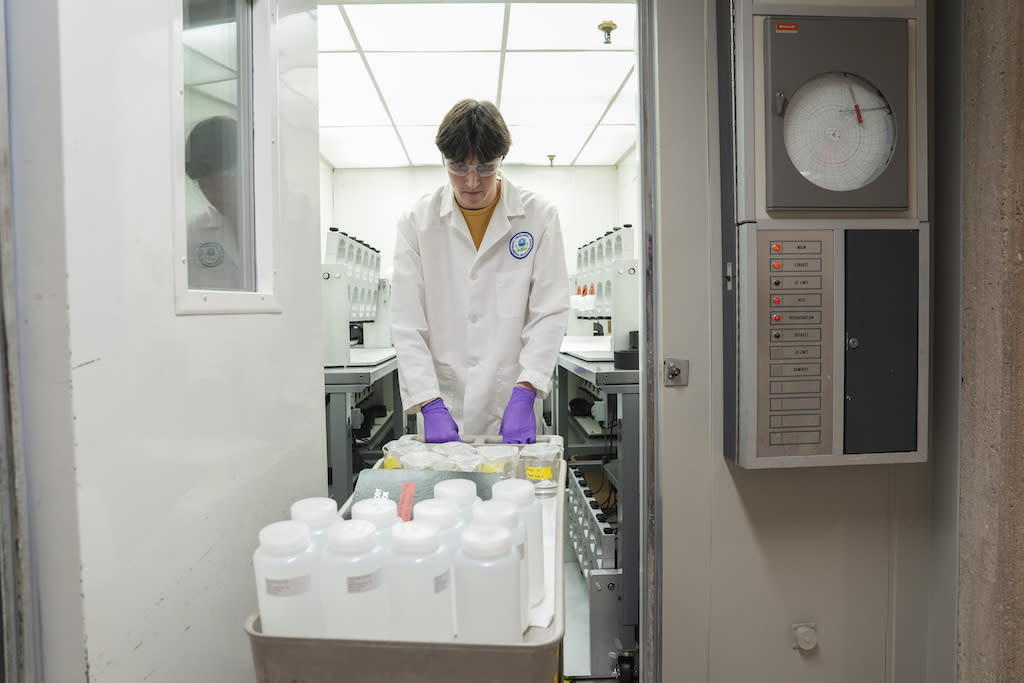 Jackson Quinn brings PFAS water samples into a temperature-controlled room at a U.S. Environmental Protection Agency lab in Cincinnati in April. In the coming years, states will need to enforce new federal rules that require drinking water systems to test for PFAS and clean up their water if contamination is found. (Photo by Joshua A. Bickel/The Associated Press)