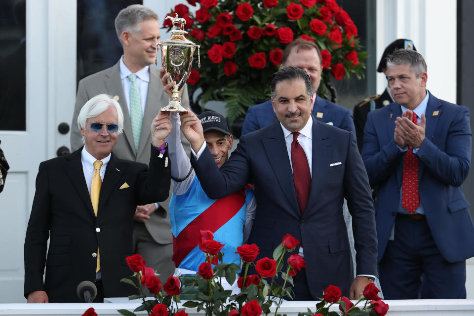 (L-R) Trainer Bob Baffert, jockey John Velazquez, and owner Amr Zedan of Medina Spirit raise the trophy after winning the 147th running of the Kentucky Derby at Churchill Downs on May 1, 2021 in Louisville, Kentucky. / Credit: Getty Images