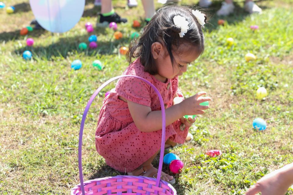 Layla Villa, 1, opens an Easter egg at Corpus Christi Parks and Recreation's Egg Hunt by the Bay at Water's Edge Park on Saturday, March 25, 2023.