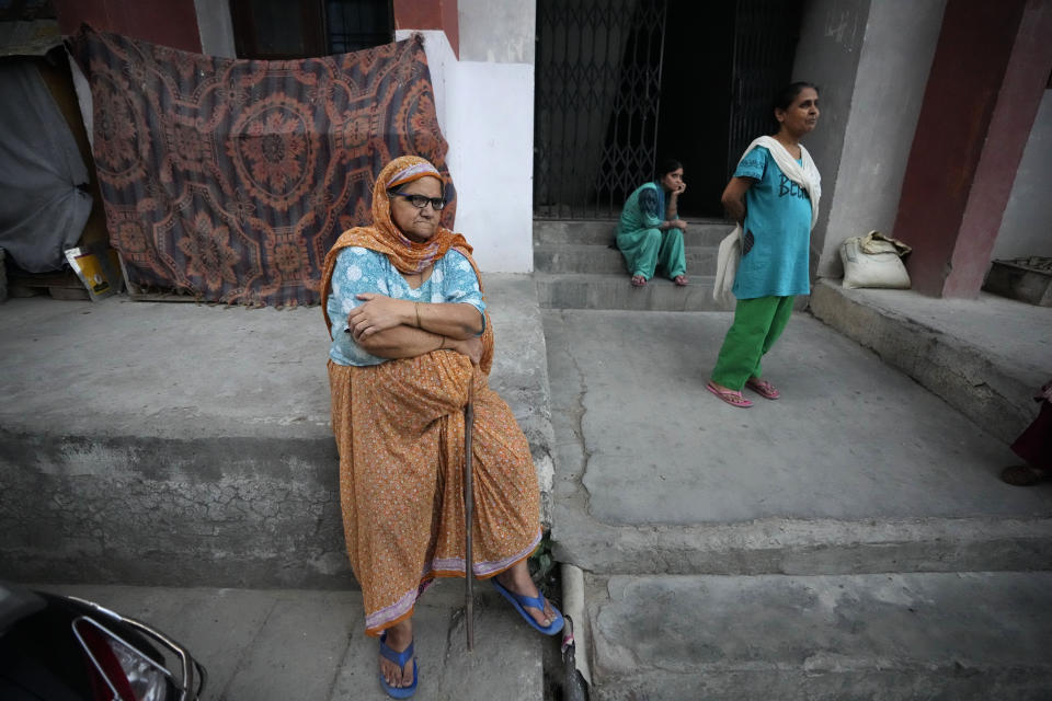 Kashmir's minority Hindu women, who are locally known as Pandits, sit at Mutthi migrant camp on the outskirts of Jammu, India, June 10, 2022. Pandits have long fretted over their place in the disputed region. Most of an estimated 200,000 of them fled Kashmir in the 1990s when an armed rebellion against Indian rule began. (AP Photo/Channi Anand) )