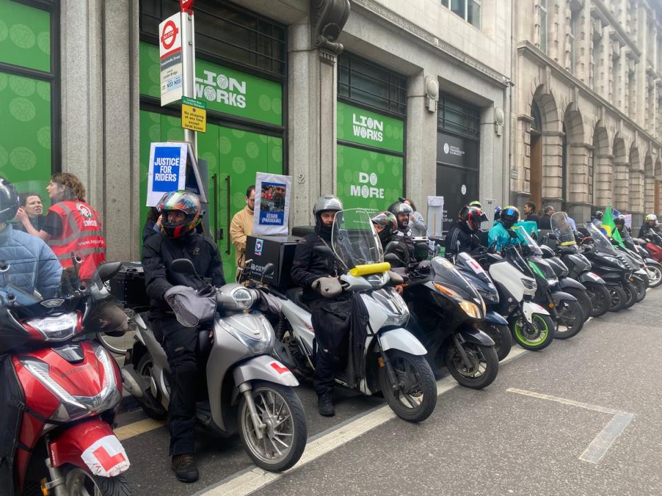Deliveroo drivers during a demonstration outside the offices of White & Case law firm in London (Rebecca Speare-Cole/PA Wire)