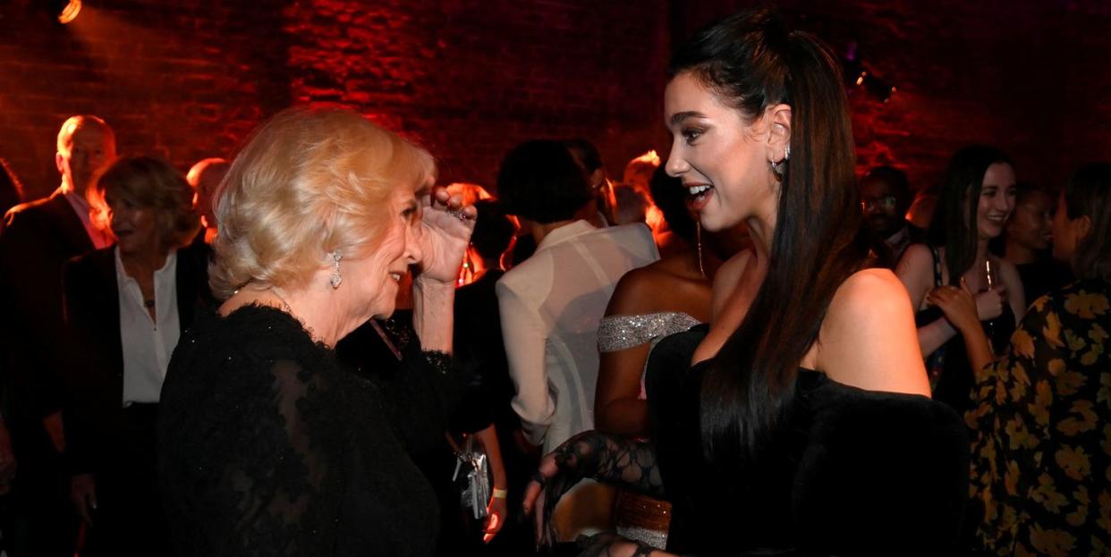 london, england   october 17 camilla, queen consort meets singer dua lipa at the 2022 booker prize for fiction ceremony at the roundhouse, on october 17, 2022, in london, england photo by toby melville   wpa poolgetty images