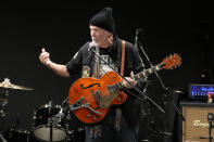 Canadian rock legend Randy Bachman performs as he plays with his reunited Gretsch guitar during the Lost and Found Guitar Exchange Ceremony Friday, July 1, 2022, at Canadian Embassy in Tokyo. Bachman’s long-held dream came true Friday when he was reunited in Tokyo with a beloved guitar nearly a half-century after it was stolen from a Toronto hotel. Bachman, 78, a former member of The Guess Who, received the guitar from a Japanese musician who had bought it at a Tokyo store in 2014 without knowing its history. (AP Photo/Eugene Hoshiko)