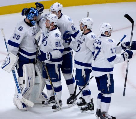 Tampa Bay Lightning players including goalie Ben Bishop (30) and Steven Stamkos (91) celebrate their victory against the Montreal Canadiens in game two of the second round of the 2015 Stanley Cup Playoffs at the Bell Centre. Mandatory Credit: Eric Bolte-USA TODAY Sports
