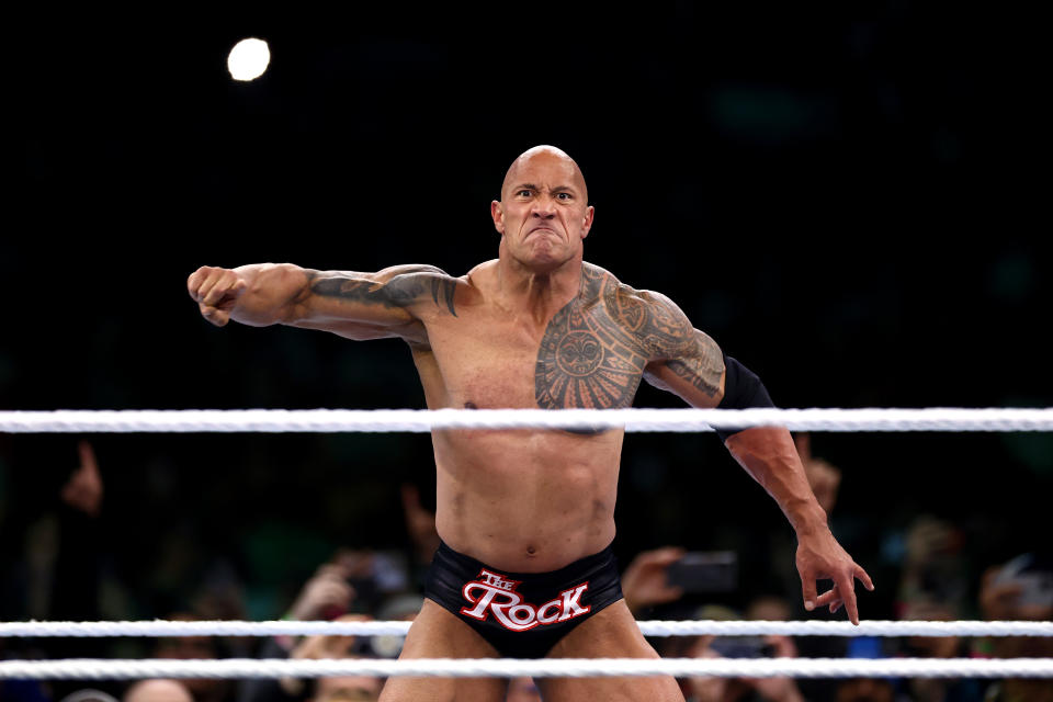 PHILADELPHIA, PENNSYLVANIA - APRIL 06: Dwayne "The Rock" Johnson reacts during a tag team fight against Cody Rhodes and Seth "Freakin" Rollins during Night One of WrestleMania 40 at Lincoln Financial Field on April 06, 2024 in Philadelphia, Pennsylvania.  (Photo by Tim Nwachukwu/Getty Images)