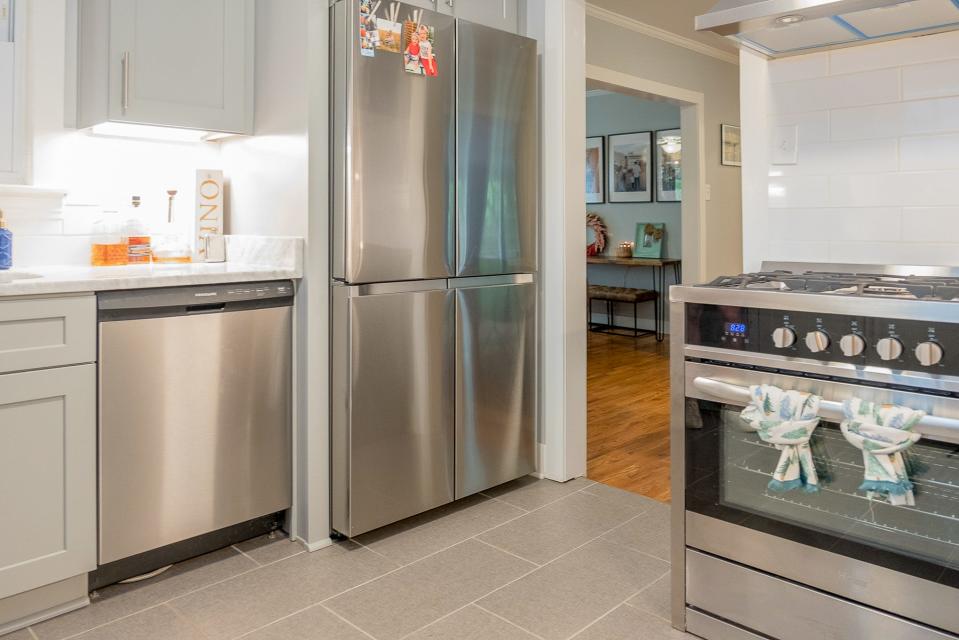 The kitchen shines with new stainless steel appliances and new flooring.