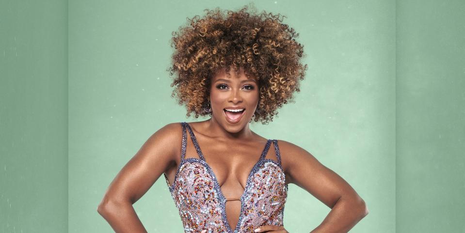 strictly come dancing star fleur east smiling with her mouth open against a green background