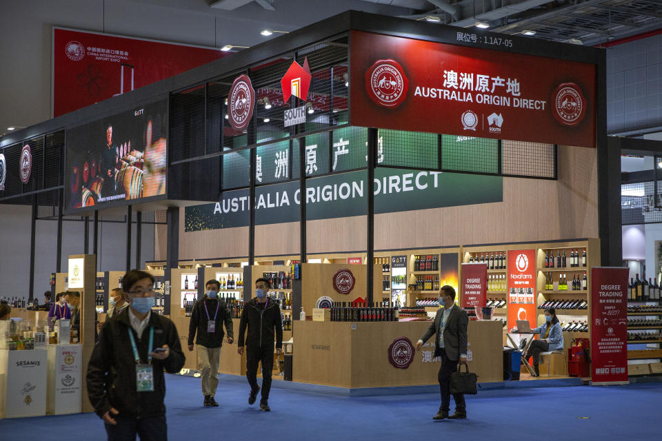 Visitors wearing face masks walk past a display of Australian wines and other agricultural products at the China International Import Expo (CIIE) in Shanghai, China, Nov. 5, 2020. Australia's Trade and Tourism Minister Don Farrell appears to be making progress in restoring a nearly decade-long rift in relations with China during a visit to Beijing. Farrell was holding meetings and visiting businesses on Friday, May, 12, 2023 in a sign that relations were getting back on track. (AP Photo/Mark Schiefelbein)