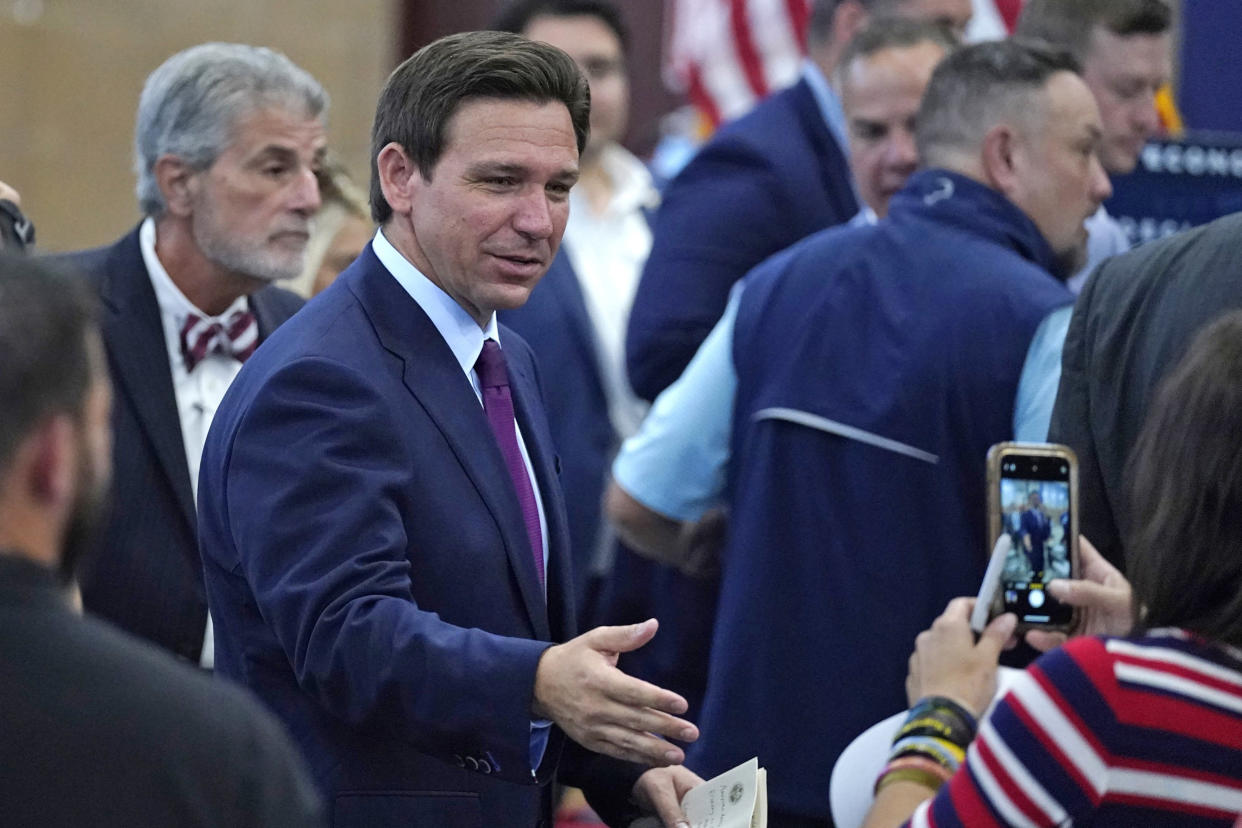 Florida Gov. Ron DeSantis shakes hands during a campaign event, Monday, July 31, 2023, in Rochester, N.H.  (Charles Krupa / AP)