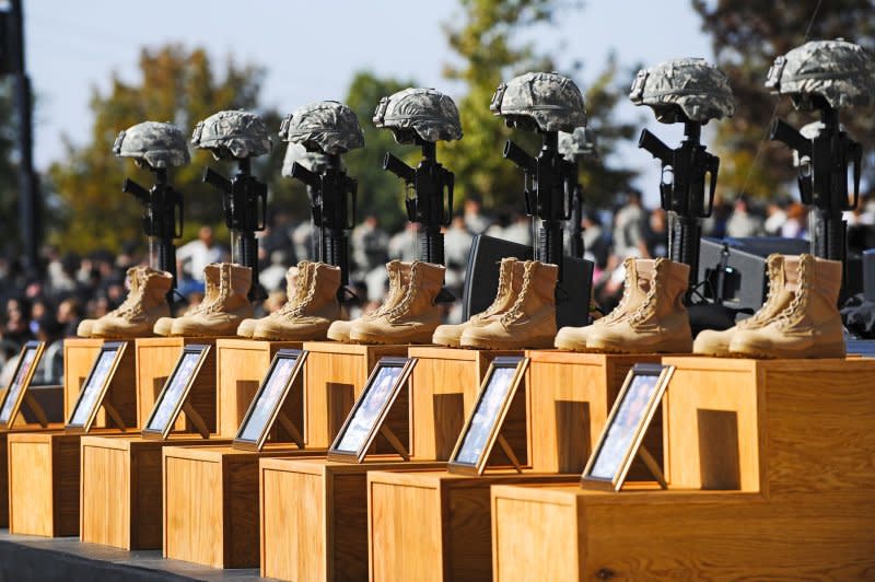 Soldier's crosses -- boots, rifles and helmets -- sit on the podium at the memorial service for the 12 soldiers and one civilian killed at Fort Hood U.S Army Post near Killeen, Texas, on November 10, 2009. File Photo by Tannen Maury/Pool