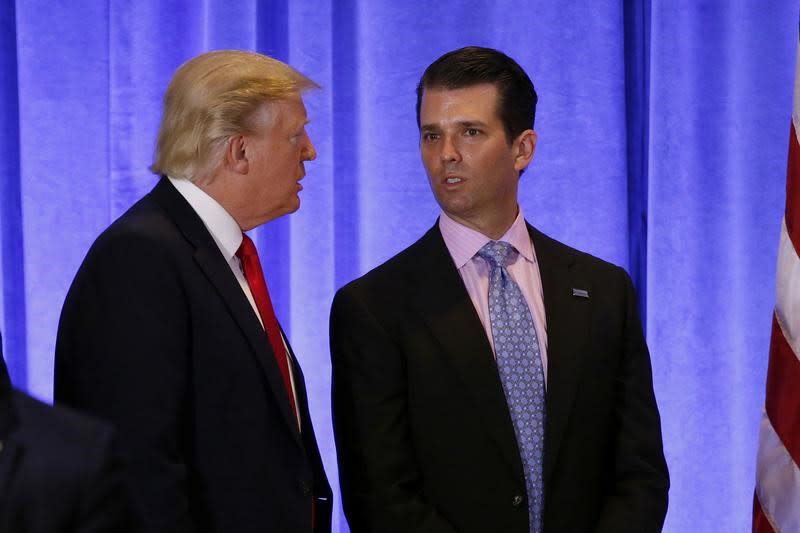 U.S. President-elect Donald Trump speaks with his son Donald Trump Jr. during a news conference in the lobby of Trump Tower in Manhattan, New York City, U.S., January 11, 2017. REUTERS/Lucas Jackson  