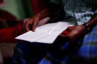 Ayub Salm holds the draft list of the National Register of Citizens (NRC) of his family in Dhubri district, in the northeastern state of Assam, India August 2, 2018. Picture taken August 2, 2018. REUTERS/Adnan Abidi