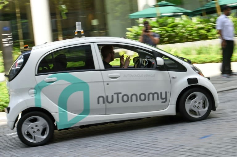 A safety driver sits in a moving driverless car during a public trial run by Southeast Asia's leading ride-hailing firm Grab in Singapore on September 23, 2016