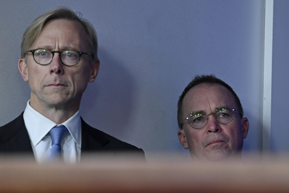 Brian Hook, U.S. special representative for Iran at the U.S. State Department, left, and acting White House chief of staff Mick Mulvaney, right, listen during a briefing at the White House in Washington, Friday, Jan. 10, 2020, with Treasury Secretary Steven Mnuchin and Secretary of State Mike Pompeo. (AP Photo/Susan Walsh)